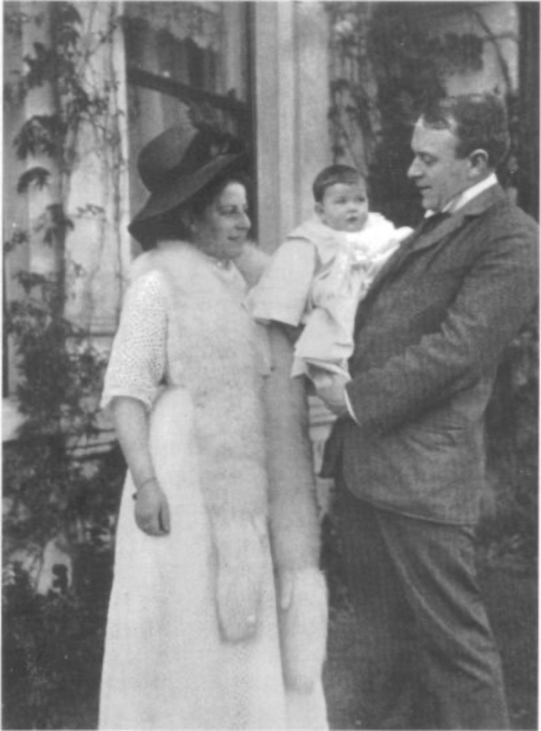 Thomas Andrews standing with wife Helen, holding child, c. 1911